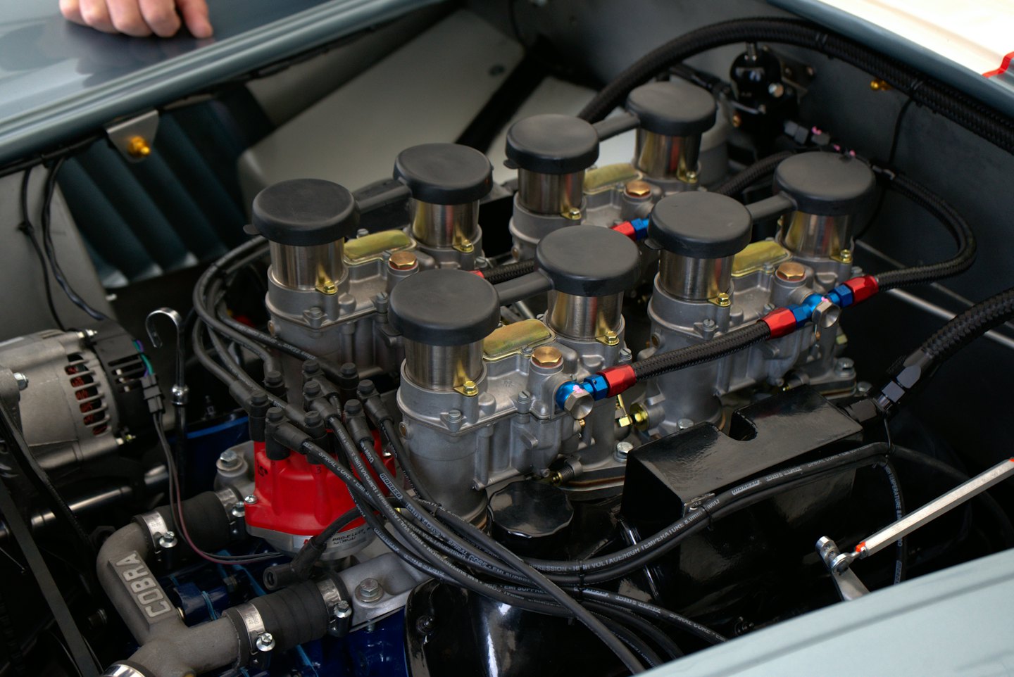 A mechanic inspects the intricate components of a V8 engine.